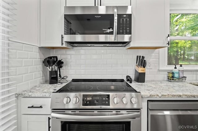 12305 Leesburg Cir, Midlothian, VA 23112 - kitchen with appliances with stainless steel finishes, white cabinets, backsplash, and light stone counters