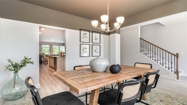 7000 Greenholm Pl, Chesterfield, VA 23234 - dining area featuring light wood-type flooring, a chandelier, and stairs