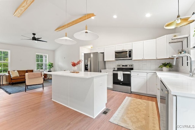 26354 Old Pitts, Ruther Glen, VA 22546 - kitchen with stainless steel appliances, backsplash, white cabinetry, light countertops, and light wood-style floors