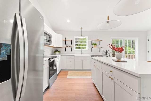 26354 Old Pitts, Ruther Glen, VA 22546 - kitchen with appliances with stainless steel finishes, open shelves, backsplash, light wood finished floors, and light countertops
