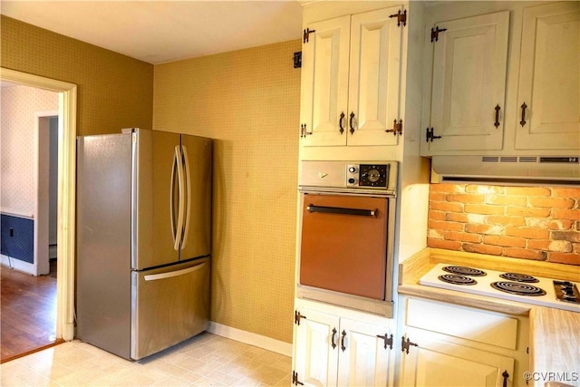 1208 Amesbury Ln, Richmond, VA 23227 - kitchen featuring freestanding refrigerator, oven, under cabinet range hood, white electric cooktop, and light countertops