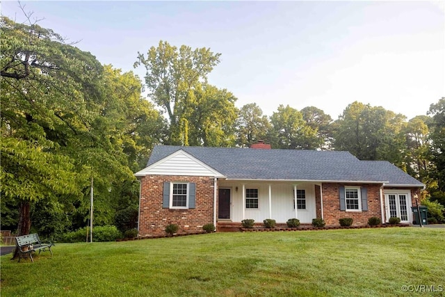 1208 Amesbury Ln, Richmond, VA 23227 - view of front facade featuring brick siding, a porch, a front lawn, a chimney, and a shingled roof
