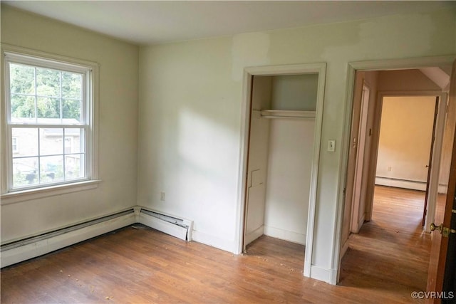 1208 Amesbury Ln, Richmond, VA 23227 - unfurnished bedroom featuring a baseboard radiator, light wood-style flooring, and a closet