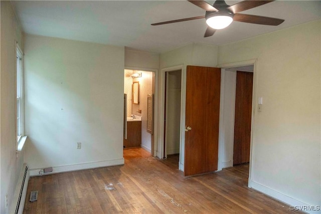 1208 Amesbury Ln, Richmond, VA 23227 - unfurnished bedroom featuring a baseboard radiator, wood finished floors, ensuite bathroom, and a ceiling fan