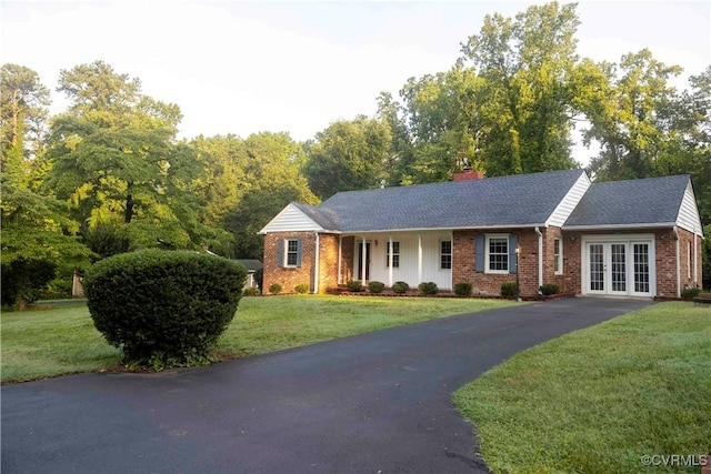1208 Amesbury Ln, Richmond, VA 23227 - ranch-style house featuring french doors, brick siding, driveway, a front lawn, and a chimney