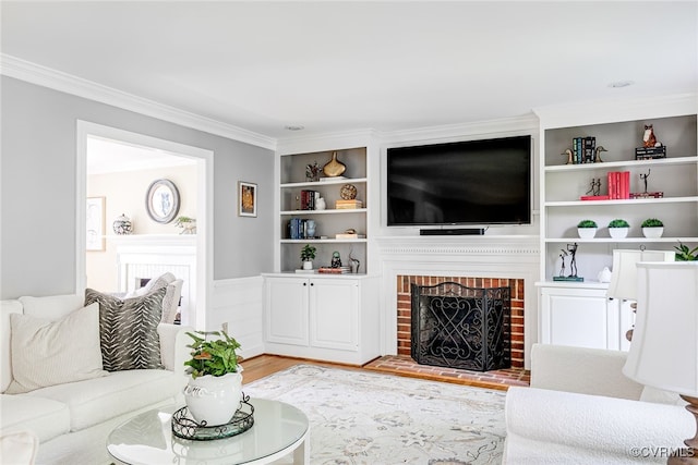 105 Williamson Ct, Henrico, VA 23229 - living area featuring built in shelves, light wood-style floors, ornamental molding, a brick fireplace, and wainscoting