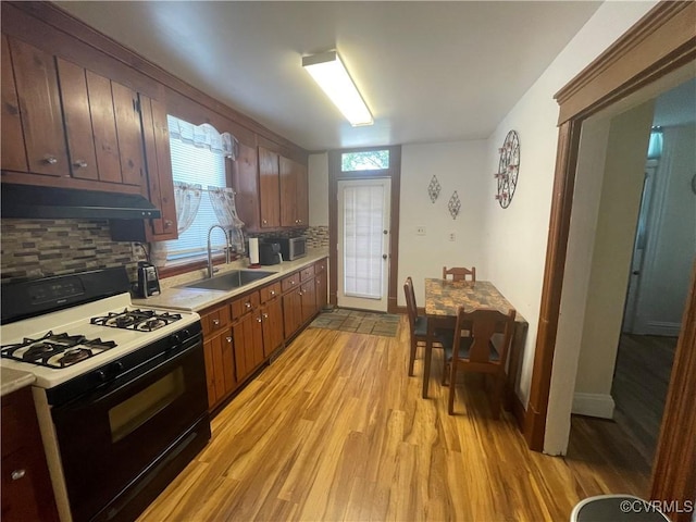 319 W 27th St, Richmond, VA 23225 - kitchen featuring range with gas cooktop, under cabinet range hood, light wood-style floors, backsplash, and light countertops