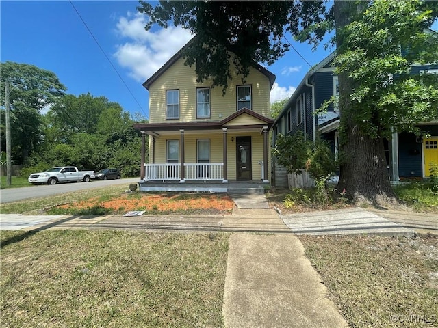 319 W 27th St, Richmond, VA 23225 - view of front facade featuring covered porch and a front lawn