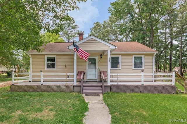 3614 Madison St, Prince George, VA 23860 - view of front of house with a front yard, a chimney, a deck, and roof with shingles
