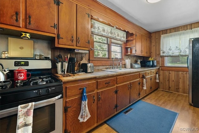 3614 Madison St, Prince George, VA 23860 - kitchen with stainless steel appliances, healthy amount of natural light, light countertops, brown cabinetry, and wood walls