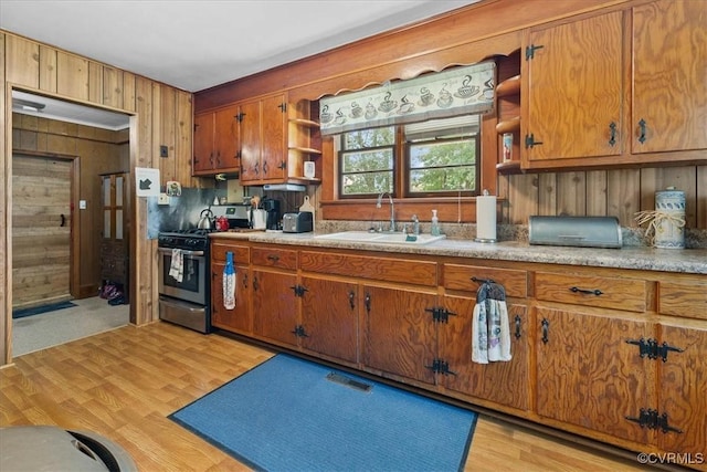 3614 Madison St, Prince George, VA 23860 - kitchen featuring stainless steel gas range, open shelves, brown cabinets, and wood walls