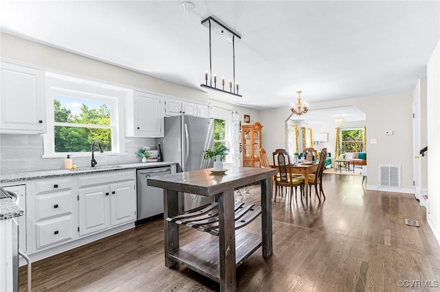 8101 Lake Shore Dr, North Chesterfield, VA 23235 - kitchen with stainless steel appliances, dark wood-type flooring, white cabinets, and light stone counters