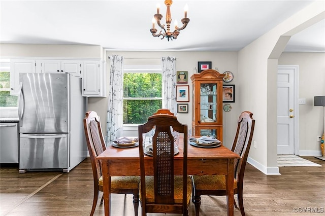 8101 Lake Shore Dr, North Chesterfield, VA 23235 - dining area with a chandelier, dark wood finished floors, and arched walkways
