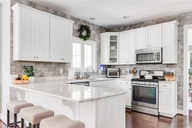 1240 Miners Trail Rd, Midlothian, VA 23114 - kitchen featuring appliances with stainless steel finishes, a peninsula, and white cabinetry