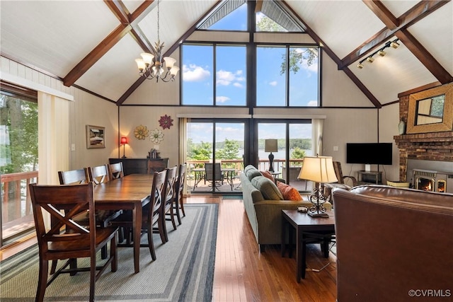 6131 Kellys Gln, Mineral, VA 23117 - dining room featuring high vaulted ceiling, hardwood / wood-style floors, beamed ceiling, a chandelier, and a fireplace