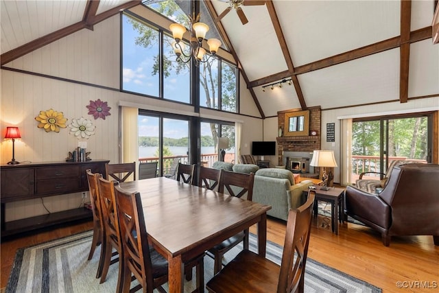 6131 Kellys Gln, Mineral, VA 23117 - dining room featuring high vaulted ceiling, wood finished floors, a brick fireplace, a chandelier, and beamed ceiling