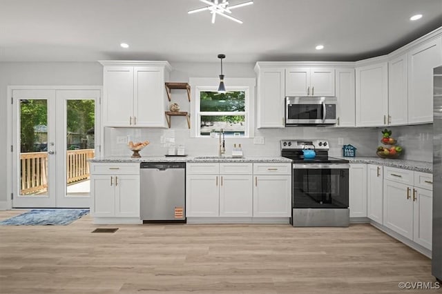 2227 S Whitehill Dr, Petersburg, VA 23803 - kitchen featuring stainless steel appliances, healthy amount of natural light, white cabinets, decorative backsplash, and recessed lighting