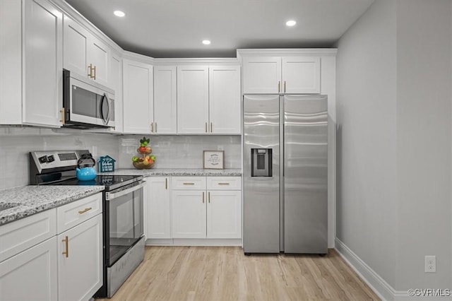 2227 S Whitehill Dr, Petersburg, VA 23803 - kitchen with stainless steel appliances, light wood-style flooring, white cabinets, backsplash, and recessed lighting