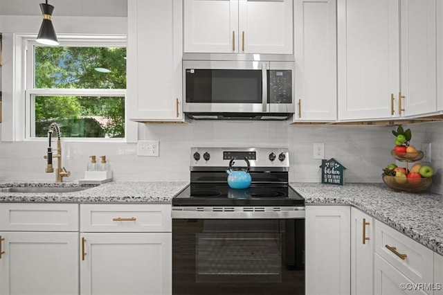2227 S Whitehill Dr, Petersburg, VA 23803 - kitchen with stainless steel appliances, white cabinets, tasteful backsplash, and light stone countertops