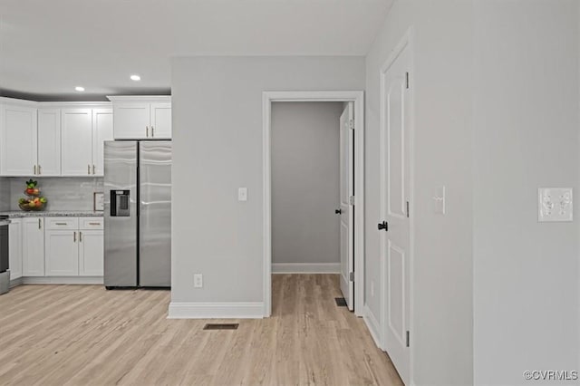 2227 S Whitehill Dr, Petersburg, VA 23803 - kitchen featuring stainless steel fridge, light wood finished floors, white cabinets, tasteful backsplash, and recessed lighting