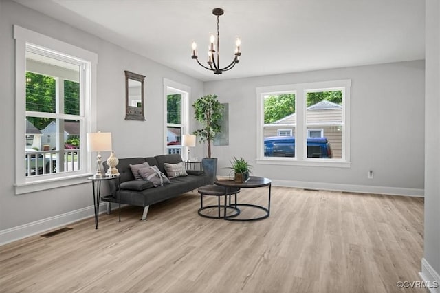 2227 S Whitehill Dr, Petersburg, VA 23803 - living room featuring plenty of natural light, wood finished floors, and a chandelier