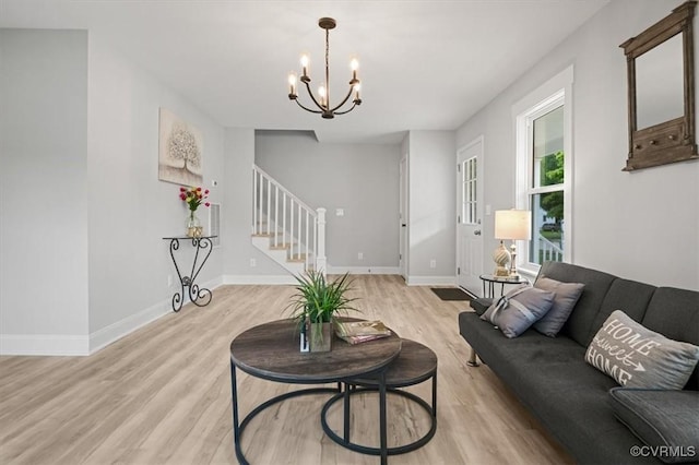 2227 S Whitehill Dr, Petersburg, VA 23803 - living room with light wood-type flooring, stairs, and a chandelier