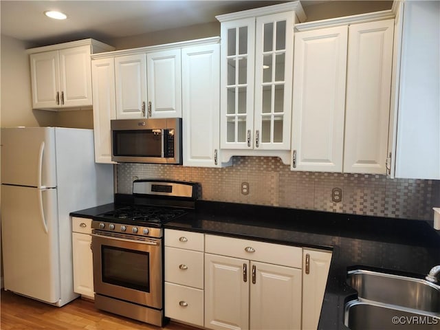 3902 Amberleigh Blvd, Chesterfield, VA 23236 - kitchen featuring stainless steel appliances, white cabinetry, backsplash, glass insert cabinets, and recessed lighting