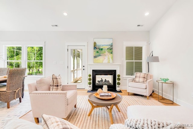 9157 Terroir Ln, New Kent, VA 23124 - living room featuring light wood-type flooring, a multi sided fireplace, and recessed lighting