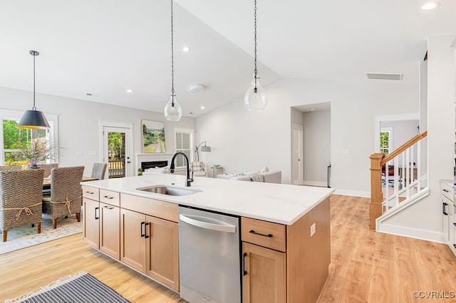 9157 Terroir Ln, New Kent, VA 23124 - kitchen with stainless steel dishwasher, light wood finished floors, plenty of natural light, a center island with sink, and lofted ceiling