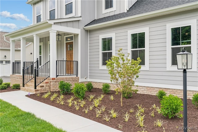 9130 Terroir Ln, New Kent, VA 23124 - view of exterior entry with a porch, board and batten siding, and a shingled roof