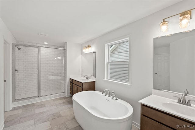 9131 Terroir Ln, New Kent, VA 23124 - full bathroom with a shower stall, two vanities, and a soaking tub