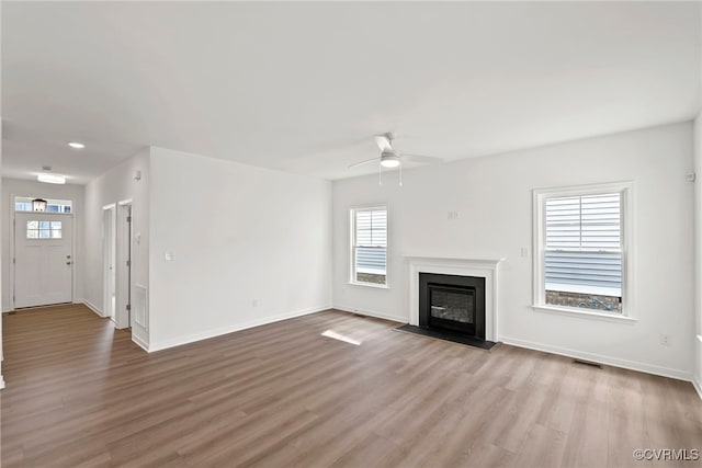9131 Terroir Ln, New Kent, VA 23124 - unfurnished living room featuring ceiling fan, wood finished floors, and a fireplace with flush hearth
