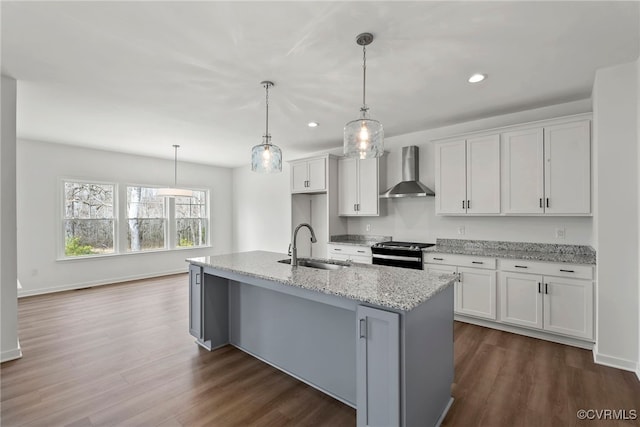 9131 Terroir Ln, New Kent, VA 23124 - kitchen with wall chimney range hood, black range with gas stovetop, white cabinetry, a center island with sink, and dark wood finished floors