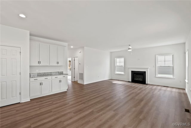 9131 Terroir Ln, New Kent, VA 23124 - unfurnished living room with a ceiling fan, wood finished floors, recessed lighting, and a glass covered fireplace