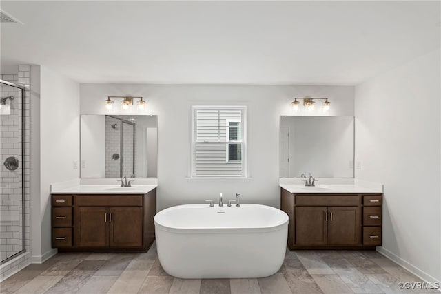 9131 Terroir Ln, New Kent, VA 23124 - bathroom featuring a shower stall, a freestanding bath, and two vanities