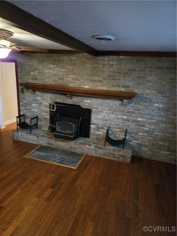 2707 Academy Rd, Powhatan, VA 23139 - unfurnished living room with a wood stove, wood finished floors, and beamed ceiling