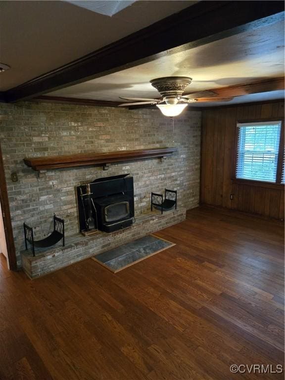 2707 Academy Rd, Powhatan, VA 23139 - unfurnished living room featuring a wood stove, wood finished floors, beamed ceiling, and ceiling fan