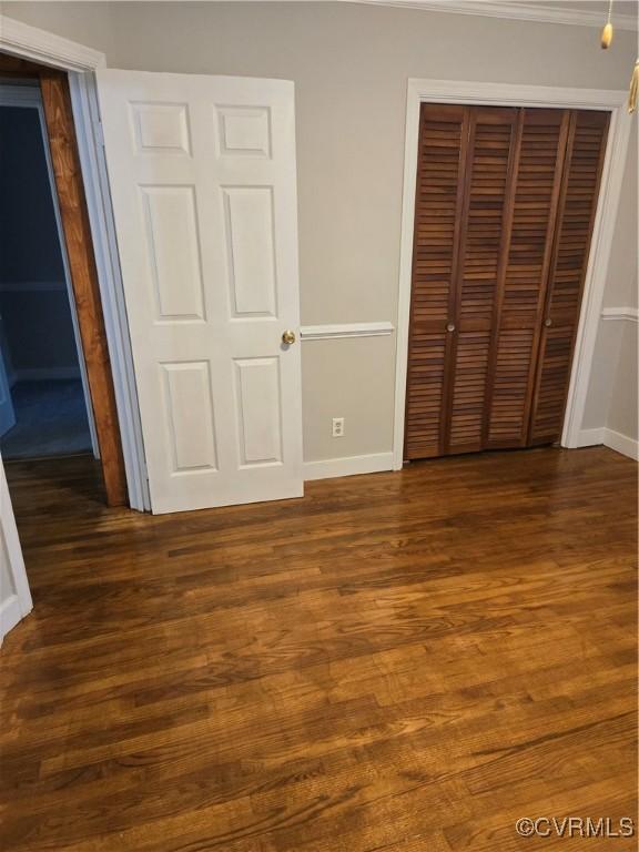 2707 Academy Rd, Powhatan, VA 23139 - unfurnished bedroom featuring a closet, dark wood-style floors, and crown molding