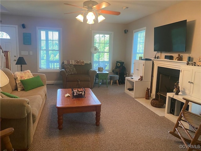 4554 Plank Rd, Kenbridge, VA 23944 - carpeted living room featuring ceiling fan and a fireplace with flush hearth