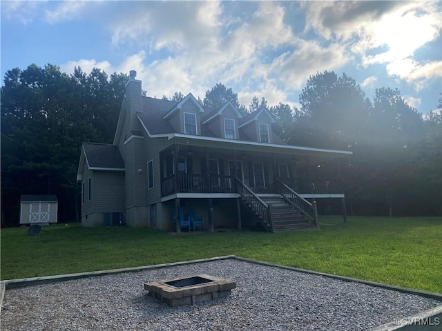 4554 Plank Rd, Kenbridge, VA 23944 - rear view of property with stairway, a yard, a storage shed, and a fire pit