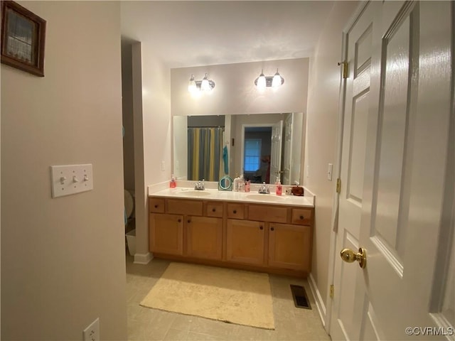 4554 Plank Rd, Kenbridge, VA 23944 - bathroom featuring double vanity and baseboards