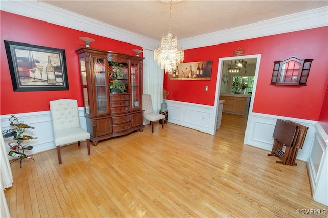 13813 Bluff Ridge Dr, Chesterfield, VA 23838 - sitting room with a chandelier, light wood finished floors, crown molding, a wainscoted wall, and a decorative wall