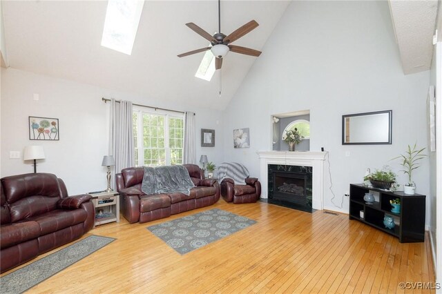 13813 Bluff Ridge Dr, Chesterfield, VA 23838 - living room featuring high vaulted ceiling, a ceiling fan, wood-type flooring, a high end fireplace, and a skylight