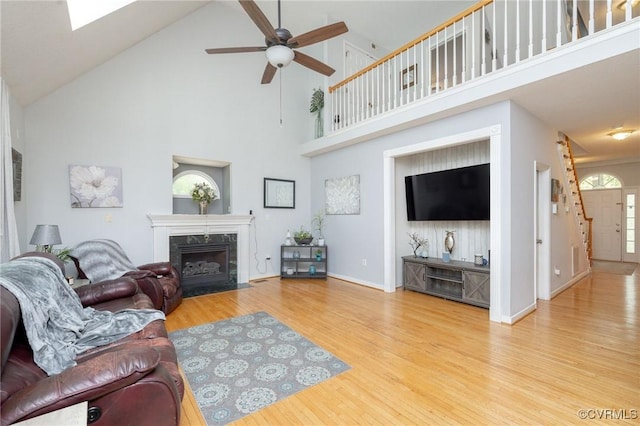 13813 Bluff Ridge Dr, Chesterfield, VA 23838 - living area featuring a high ceiling, a premium fireplace, a ceiling fan, and wood finished floors
