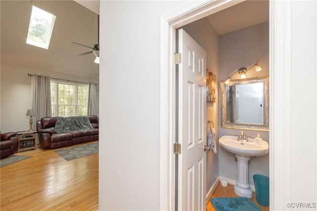 13813 Bluff Ridge Dr, Chesterfield, VA 23838 - bathroom featuring wood finished floors, a skylight, a ceiling fan, and ensuite bathroom