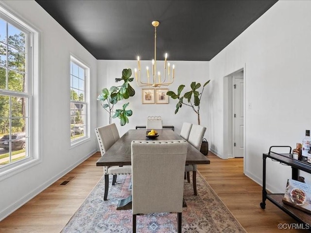 9913 Craftsbury Dr, Midlothian, VA 23112 - dining space with a chandelier and light wood-style floors