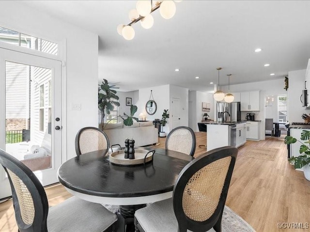 9913 Craftsbury Dr, Midlothian, VA 23112 - dining room featuring light wood-type flooring, recessed lighting, and a chandelier