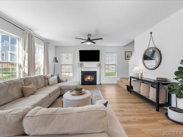 9913 Craftsbury Dr, Midlothian, VA 23112 - living room with plenty of natural light, ceiling fan, light wood-style floors, and a fireplace with flush hearth