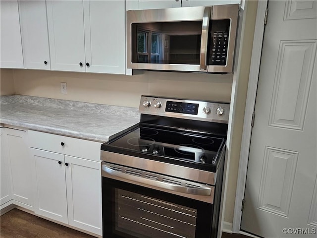 1982 Redd Shop Rd, Farmville, VA 23901 - kitchen with stainless steel appliances, light countertops, white cabinetry, and dark wood finished floors