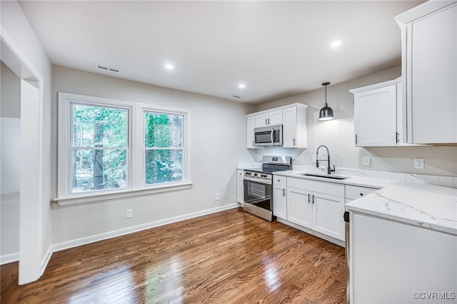 1436 Porters Mill Ter, Chesterfield, VA 23114 - kitchen with appliances with stainless steel finishes, dark wood-style floors, white cabinets, light stone countertops, and recessed lighting